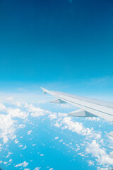 Obraz premium Aerial Scenic Airplane Wing View Above The Cumulus White Cloud