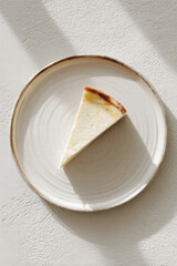 A slice of delicious spanish cheescake on plate, AI generated