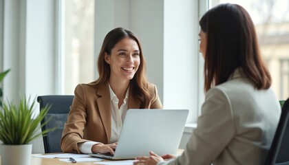 Businesswoman discusses strategy with client at modern office. Two professionals collaborate on laptop during business consultation. Focused conversation highlights teamwork, expert guidance within