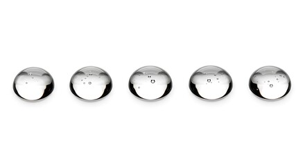 Fototapeta premium Five clear glass marbles with internal bubbles in a horizontal line spheres