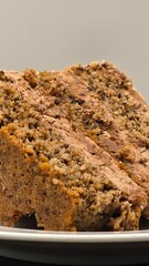 Piece of sweet chocolate cake with nuts. Delicious dessert, portion of tasty snack, closeup, vertical view