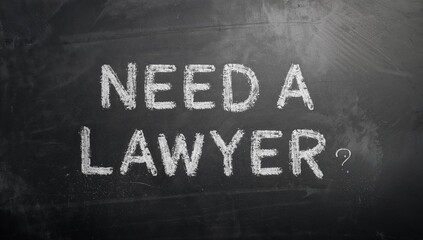 Fototapeta premium Vintage slate blackboard featuring a legal query, focusing on the importance of legal consultation