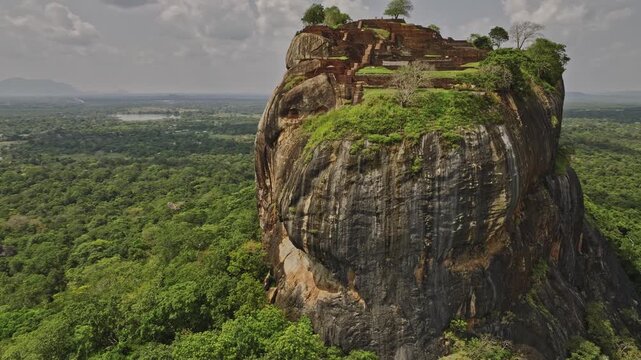 Sigiriya Sri Lanka Aerial v7 drone fly around historical and archaeological site capturing ruins of ancient city and fortress built on top of Sigiriya lion rock 4k
