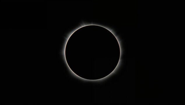 Solar eclipse with the dark moon transitioning from totality, celestial event in astronomy