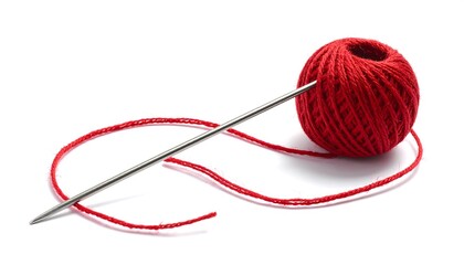 Metallic sewing needle with red thread and yarn ball on white background