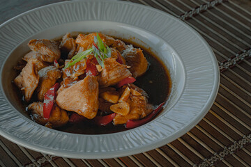 Home cooked chicken paprika stir-fry garnished with spring onions