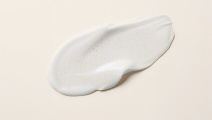 The texture of a skin care product, light application of cream on a neutral backdrop