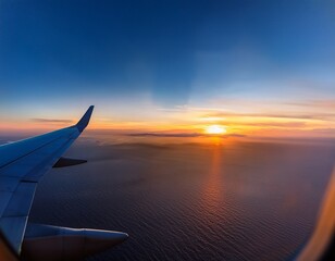 airplane window view of sunrise over ocean