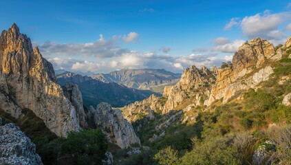 Mountainous terrain under a summer sky, ideal for travel and exploration, nature's beauty