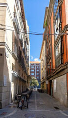 A typical street in central Madrid, lined with elegant historic buildings, balconies, and warm facades, capturing the city’s lively charm and timeless architecture