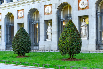 El Prado Museum on a sunny spring morning, showcasing elegant neoclassical architecture, grand statues, and lush green trees framing its bright, inviting façade with added charm