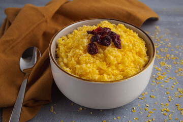 milk porridge with crushed corn grains on a gray background