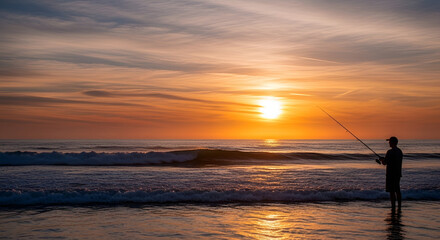 Fisherman casting line into ocean waves at sunset