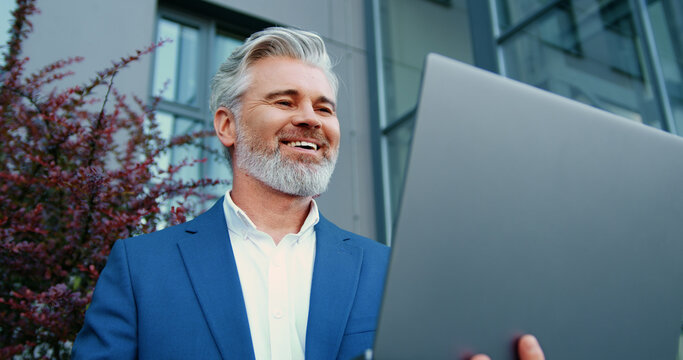 Close-up of an adult businessman joining a virtual meeting during an important online video call on a laptop. Remote communication, virtual meeting, digital business interaction