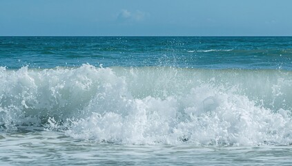 Waves crashing onto the shore under bright sunlight, soothing sound of nature, seasonal change