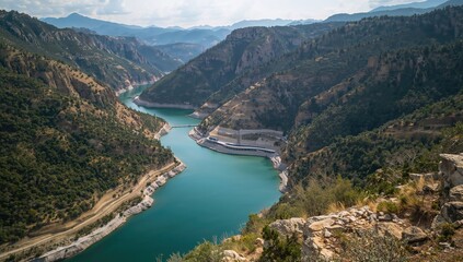 Obraz premium Aerial view of Taurus Canyon showcasing mountainous terrain, forested areas, and a constructed reservoir, highlighting preservation