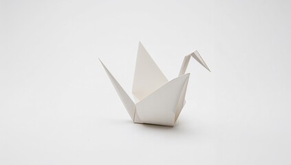 Origami crane displayed on a white surface, suitable for editorial backgrounds