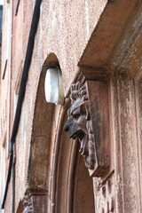 This image features a grotesque in the form of a carved stone lion's head on the facade of a building. These types of architectural details are often found above doorways or on cornices, harking back 