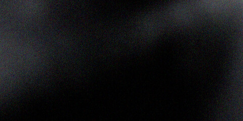 Sandblasted or brushed titanium or steel metal surface, the light reflection of the curved lines creates a smooth gradation on the dark black metallic background