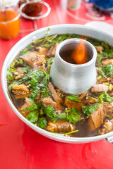 Braised beef in Thai fire hot pot. Thai style stainless steel hot pot with flame