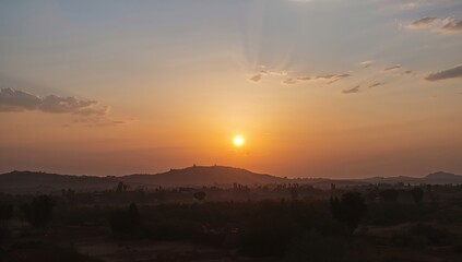 Obraz premium Sunset over a serene landscape, a symbol of summer travel and nature's beauty, Earth Day
