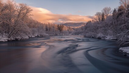 Long exposure of river water flowing through a snow-laden winter forest, showcasing seasonal change
