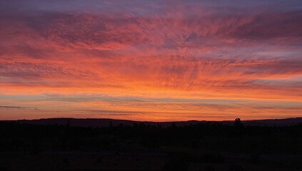 Fototapeta premium Vibrant orange twilight sky, evening atmosphere, seasonal change