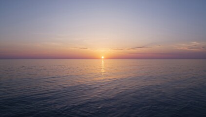 Obraz premium Calm sunset reflecting on peaceful water with a wide horizon, seasonal change