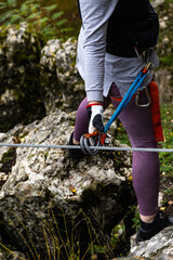 Close-up. Via ferrata. An unidentified person climbs in the mountains  with the help of fixed safety ropes. Krakow-Czestochowa Upland, Poland