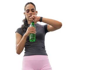 Woman opening water bottle, wearing sportswear, earbuds, and fitness tracker after exercise