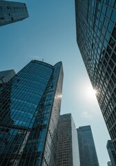 Fototapeta premium Towering glass and steel structures dominate the financial district of a large urban area under the midday sun, symbolizing economic power, vibrant, future, global