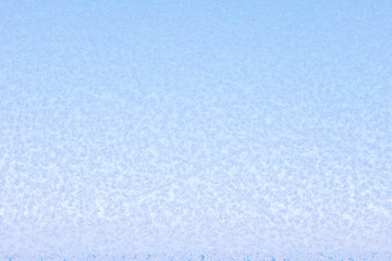 Natural frost on glass against a blue sky background. Christmas, New Year's background
