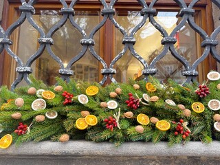Christmas garland of pine needles and dried fruits on the window