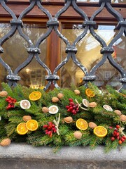 Christmas garland of pine needles and dried fruits on the window