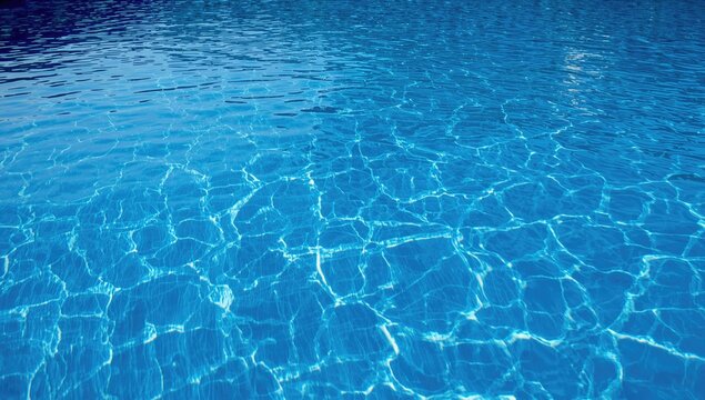 Swimming pool water with a vibrant blue hue reflecting sunlight, showcasing gentle ripples and waves, seasonal change
