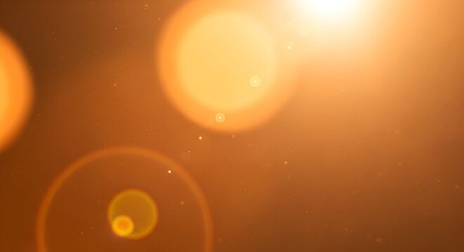 Abstract golden background features blurred lights and bokeh effect, with warm, glowing atmosphere.