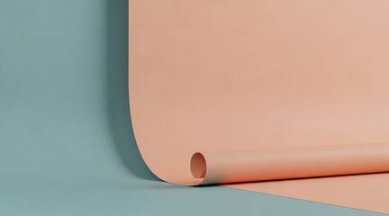 Minimalist geometric studio backdrop with curved pastel pink paper roll extending onto surface divided by light turquoise colored area background.