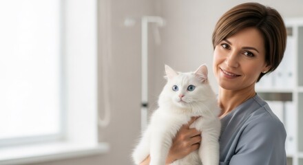 Woman veterinarian holding a beautiful white cat with blue eyes at a vet clinic. Pet healthcare, animal care, and veterinary medicine concept.