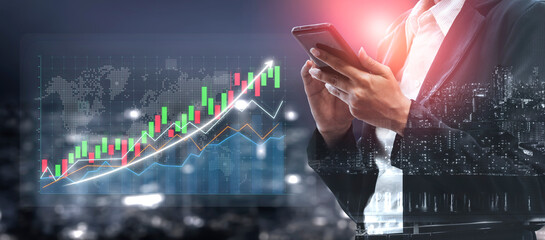 A business professional stands in a modern urban setting, using a smartphone to analyze market trends displayed on a graph overlay against a city skyline. Impute