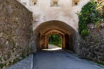 Historic Stone Archway with Shaded Path and Rustic Walls