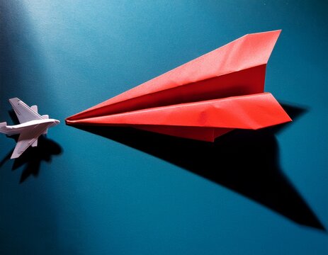 ambitious a travel by plane a red paper airplane with the shadow of the plane a paper plane with ambitions of a jet audacious aircraft