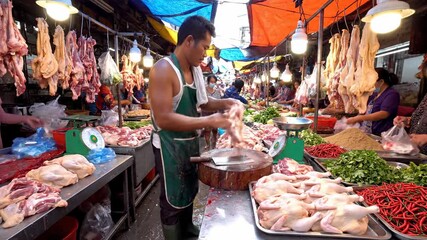 Butcher Chopping Meat in Busy Asian Market, Food Preparation