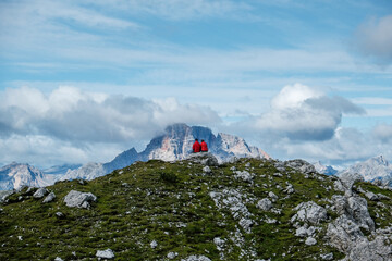 Couple admiring nature at the Tre Cime di Lavaredo (Three Peaks), Tre Cime Natural Park, Southern Dolomites, Italy. Rifugio Auronzo &ndash; Rifugio Lavaredo &ndash; Rifugio Locatelli &ndash; return via Pian di Cengia.