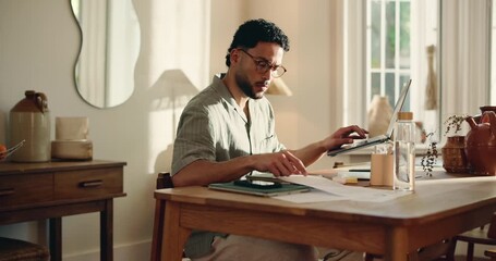 Man, documents and remote work in home with laptop for marketing campaign, checklist and admin. Freelance, person typing or computer in house for paperwork, writing creative idea or advertising plan.