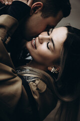 Couple sharing a romantic moment indoors with warm lighting and joyful expressions
