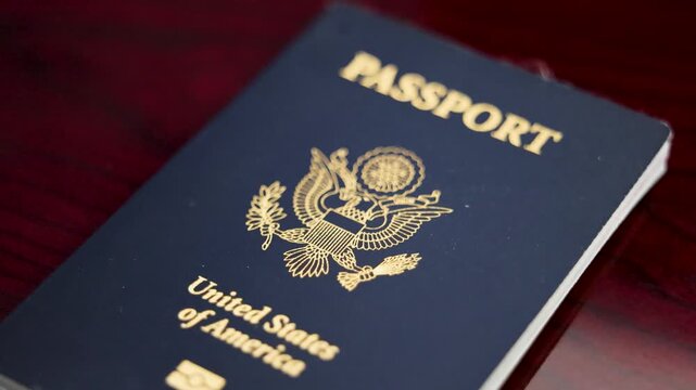 United States passport on polished wooden table travel identification 4K