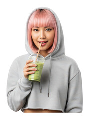 Young woman with pink hair having a green smoothie in a casual hoodie