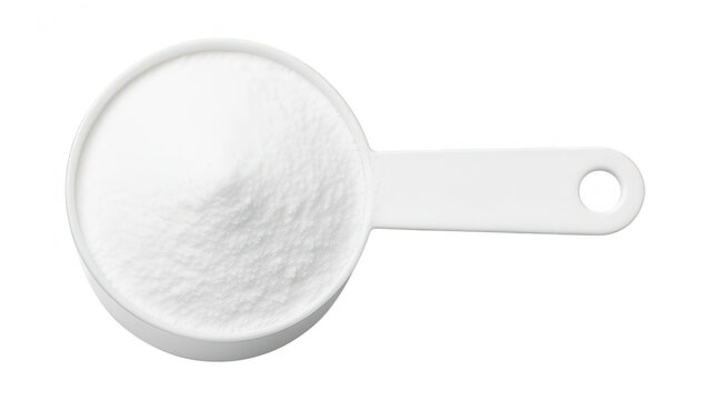 Close-up of a white measuring spoon filled with fine white powder on a white background, kitchen utensil used for cooking and baking, minimalistic
