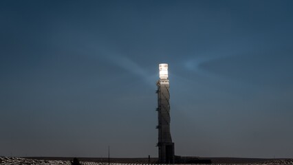 High resolution dramatic color image of a unique solar farm with a bright solar tower creating green energy- Southern Israel