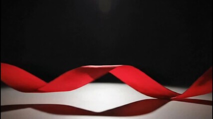 Abstract red ribbon flowing in the spotlight 8 Seconds, Loopable Footage - Powered by Adobe